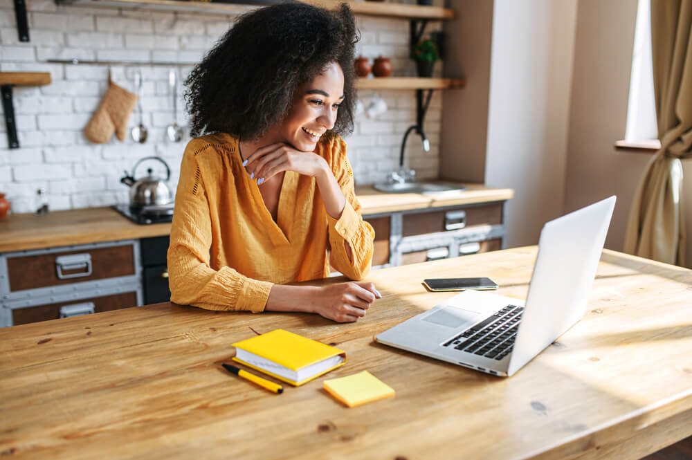 A,Cheerful,Mixed-race,Girl,Uses,Laptop,For,Remote,Work,Or leadership