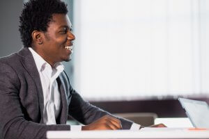 An African American man sitting at a desk