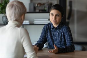 Two young women sitting and discussing