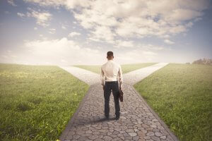 A businessman standing on the crossroad