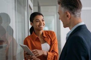 A man and a woman discussing something in the office hall