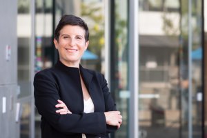 A middle aged woman with short hair posing for a photo