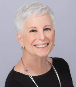 A headshot of a smiling mature lady