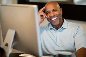 A man sitting in front of his desktop monitor