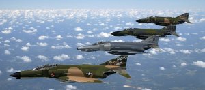 Fighter jets flying above the clouds