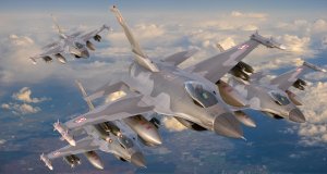 Three F-16 fighter jets in flight formation, soaring above clouds. They feature a grey camouflage pattern and red insignias on the tail fins and near the cockpit, beneath a blue sky. Farmland is faintly visible below, giving a sense of altitude and reminding us how many jobs are available in military aviation.