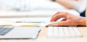 A close up of a person’s hand holding a computer mouse