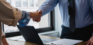A woman and a man shaking hands