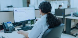 A woman working in security sitting in front of a computer
