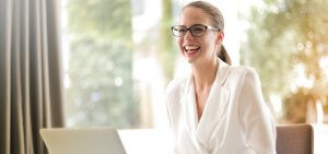A smiling woman with glasses on her face