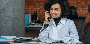 A woman talking on a telephone