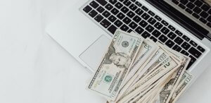 Dollar bills on a laptop