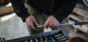 Hands of a man holding a screwdriver