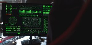 A computer desktop monitor showing data in green