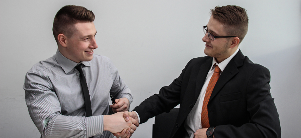 A job interviewer and interviewee shaking hands