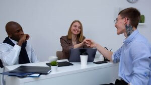 A prospective job seeker shaking hands of interviewers Arizona