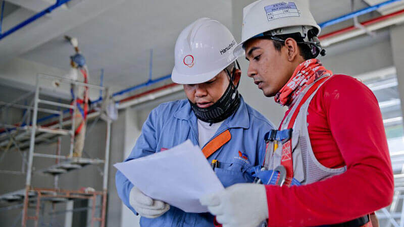 Engineers looking through a drawing Alabama