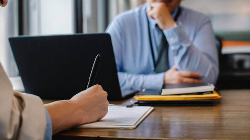 Woman filling job application form in office with boss Alabama