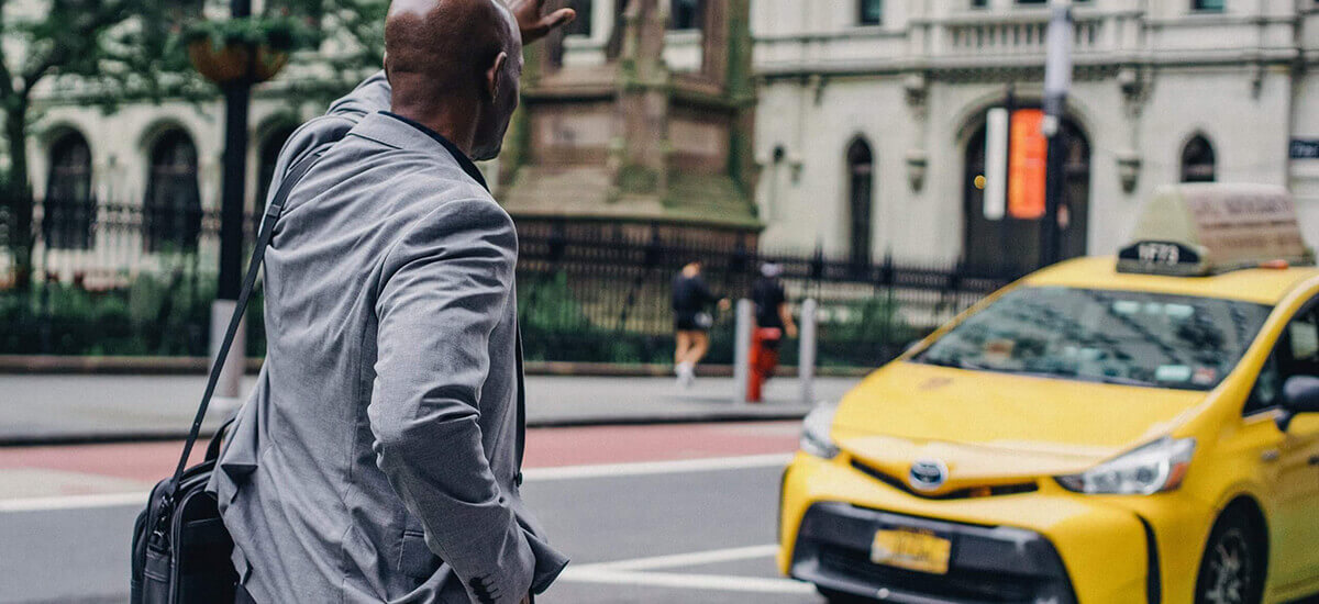 A black man trying to hail a ride