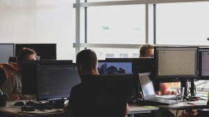 A man using a computer in an office space - Pennsylvania Careers In Government