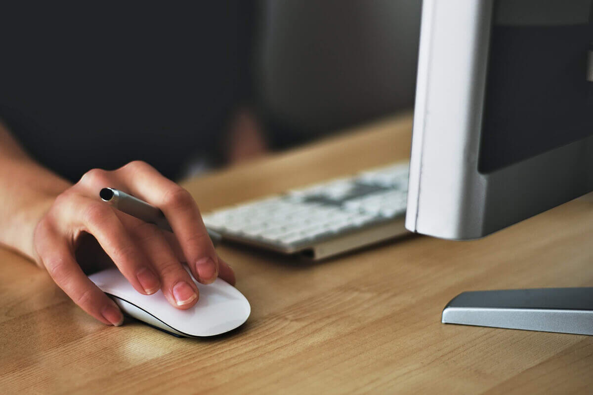 Image of a hand pressing a mouse - Broward County