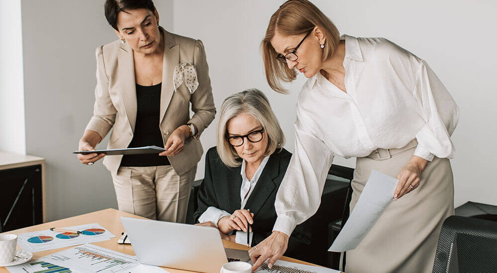 Three women looking at a laptop - Pennsylvania Careers In Government