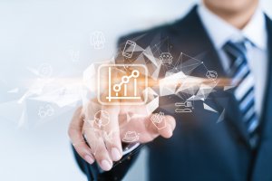 A person in a business suit points toward a virtual screen displaying an upward-trending graph icon. Surrounding the icon are various transparent icons representing different sectors—clothing, technology, real estate, and finance—symbolizing data crucial to the CISO's strategic insights.