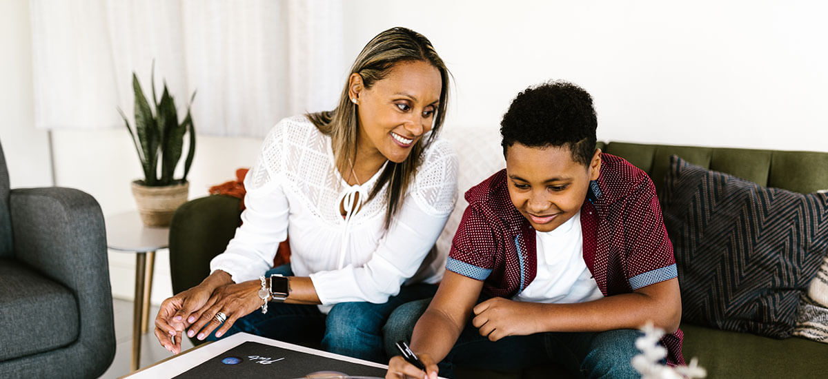 A boy and his mom in their home