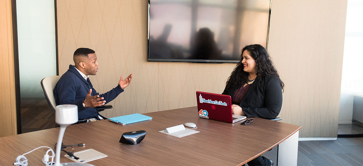 A man being interviewed by a woman