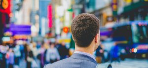 A man wearing a suit walking in the street