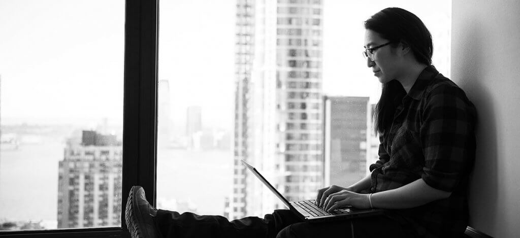 A woman pressing a laptop