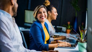 Two women and a man in an office space