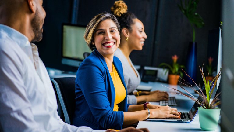 Two women and a man in an office space