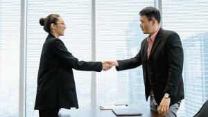 A man and a woman wearing suit shaking hands - Dallas County