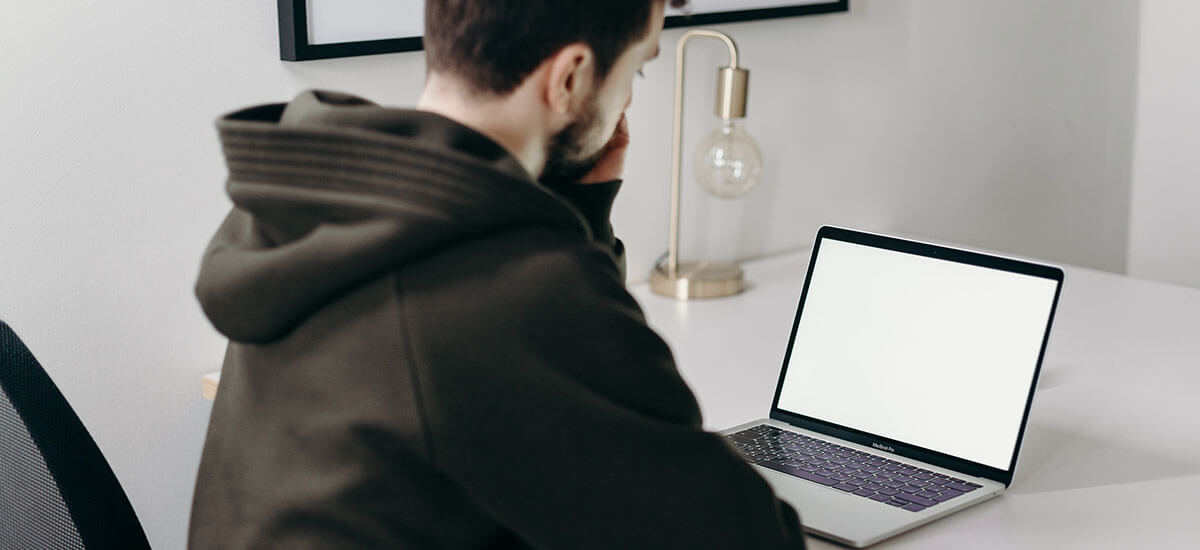 A man staring at a laptop