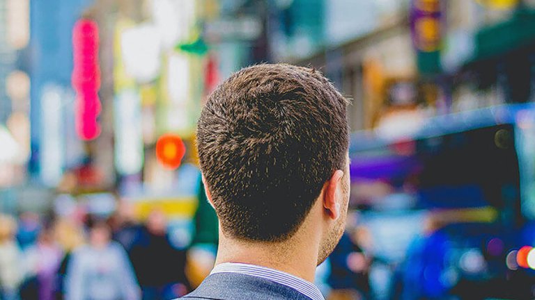 A man wearing a suit walking in the street - Tarrant County - Careers in Government