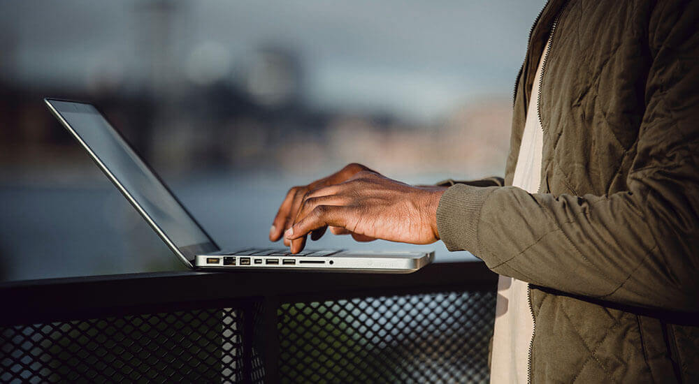 A person about to click a laptop keyboard - Santa Clara County