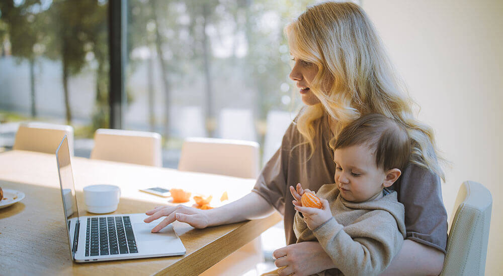 A remote-working mum pressing a laptop - Riverside County