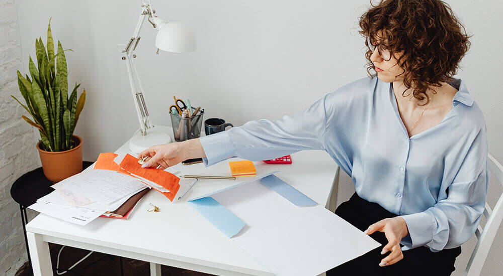 A woman arranging documents - San Bernardino County