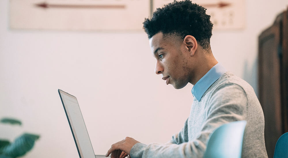 A young person using a laptop - Harris County