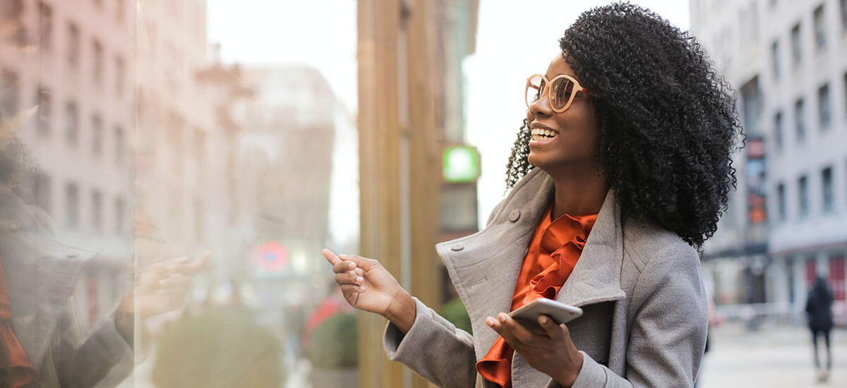 Happy Woman Smiling holding a phone with her hand