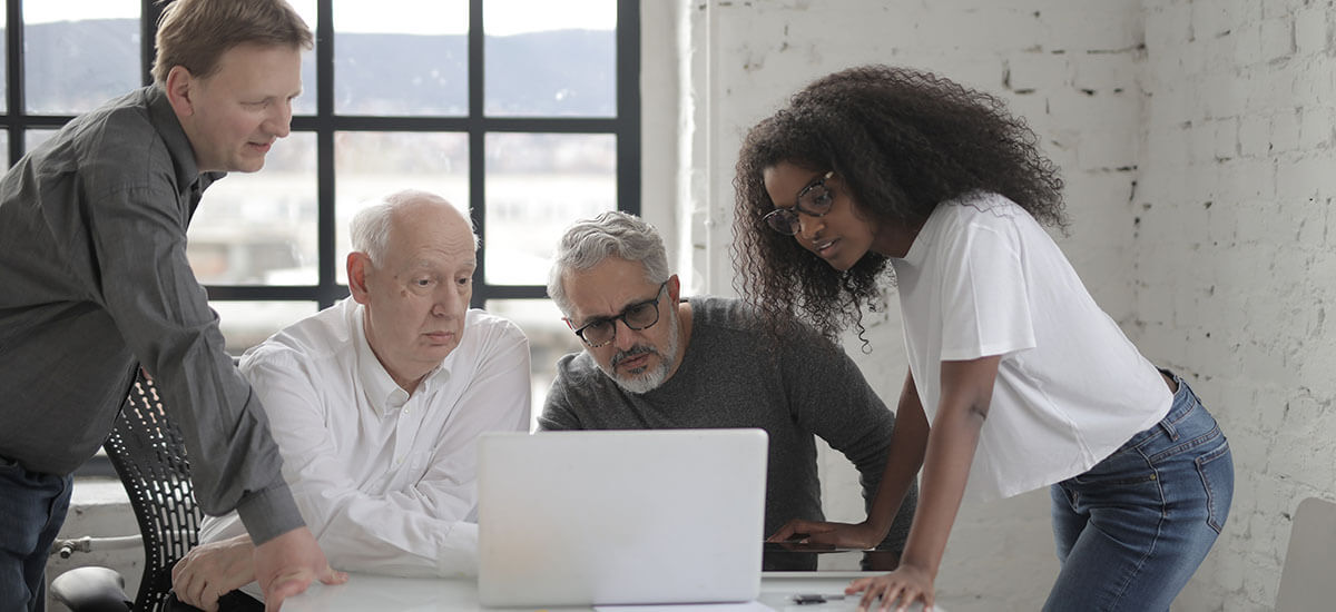 People staring at a laptop