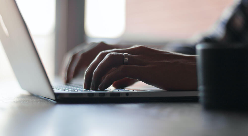 Hands pressing a laptop keyboard - Collin Country - Careers in Government