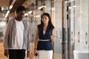 Two employees engaged in a serious talk while walking