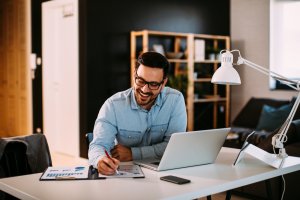 Young business man, happily working on a project