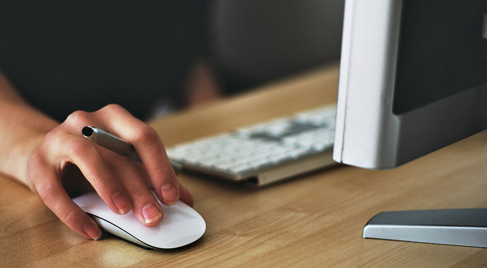 A person holding a pen and pressing a mouse - Yavapai County - Careers In Government