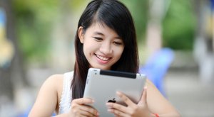 A woman holding a tablet