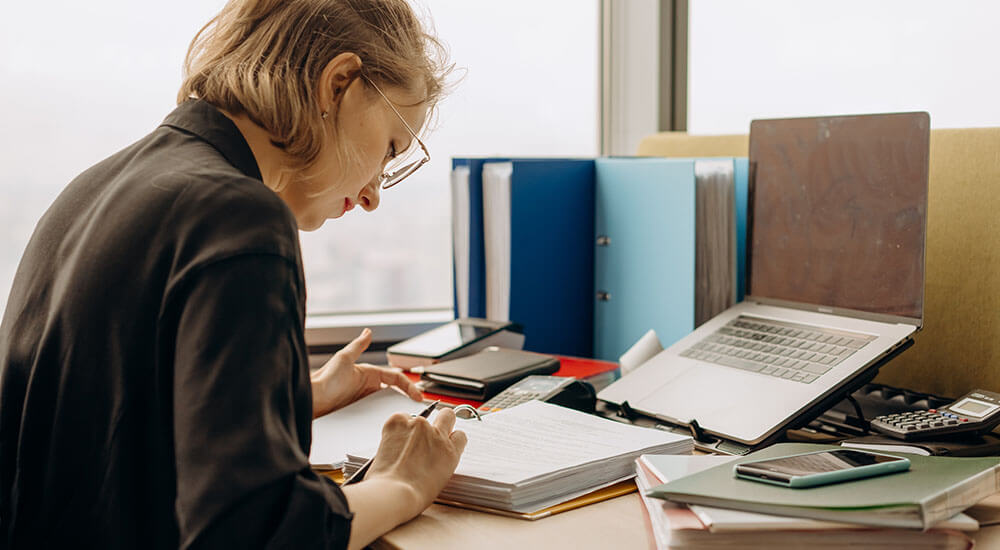 A woman wearing a blazer in an office - Colorado - Careers In Government