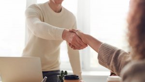 People shaking hands in an office setting