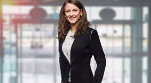 A woman wearing a suit in a building lobby